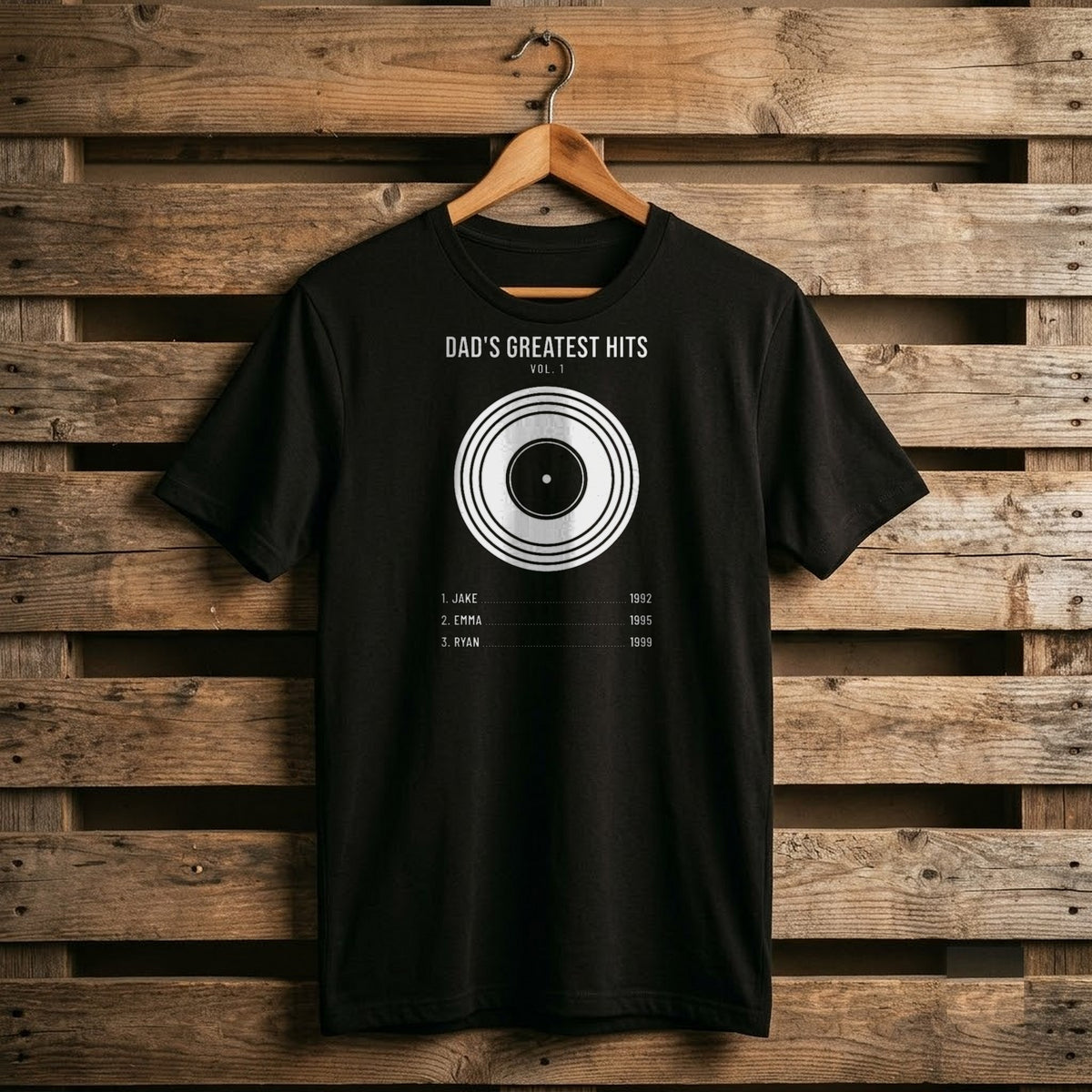 Black Dad's Greatest Hits Vol. 1 shirt with a vinyl record and a track list of kids names