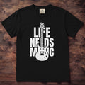 Ivory tee with LIFE NEEDS MUSIC in bold black letters and a guitar cutting through the middle