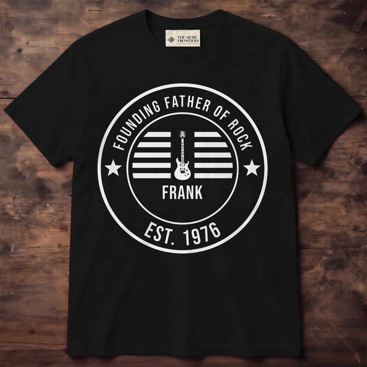 Black shirt with a white round badge: electric guitar, the name FRANK and Founding Father of Rock EST. 1976