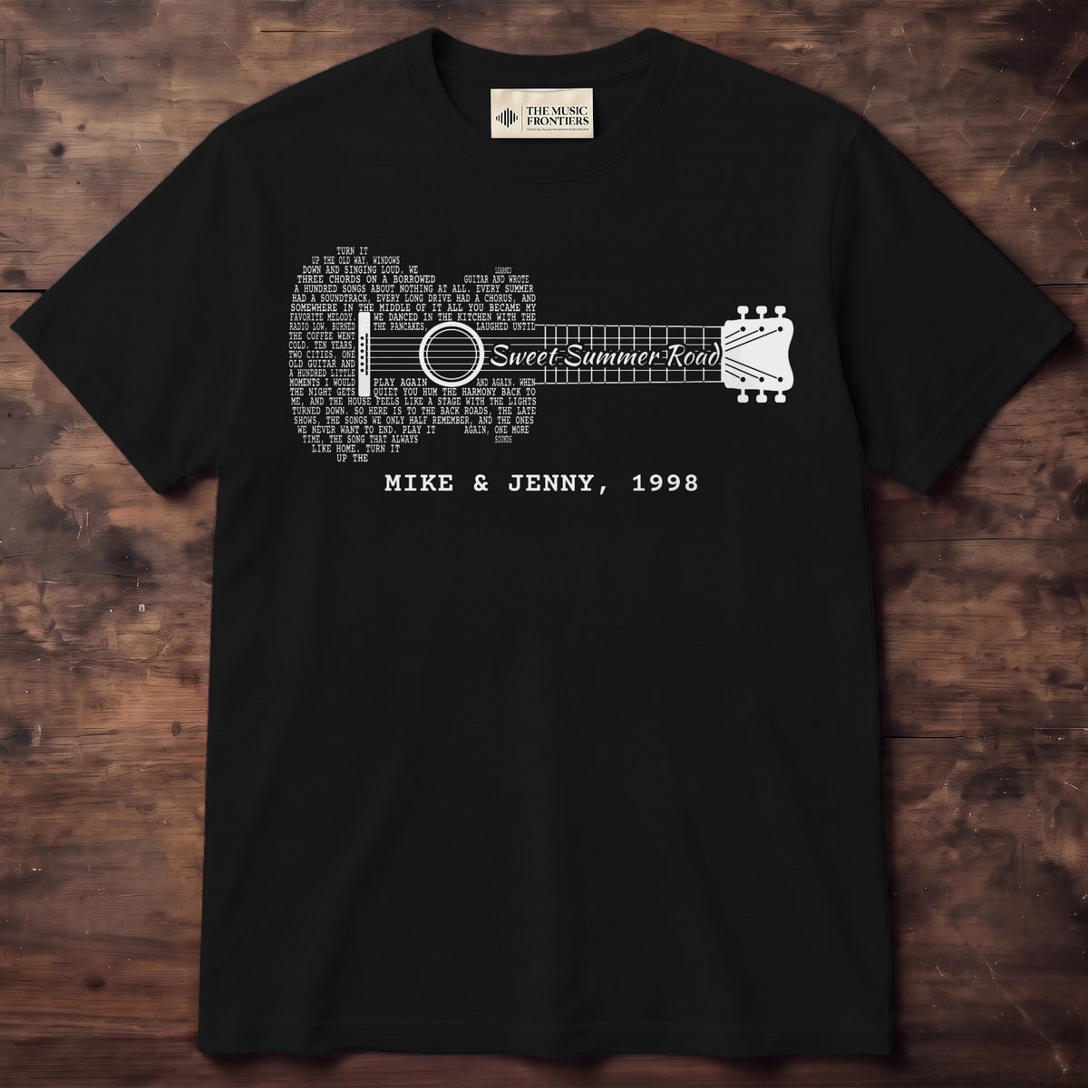 Black tee with an acoustic guitar made of song lyrics, the song title Sweet Summer Road written along the neck