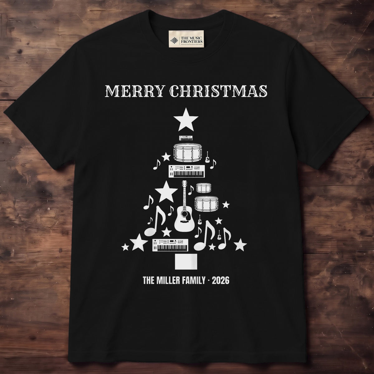 Black tee with guitars and drums arranged as a Christmas tree with a star on top and THE PARKERS 2026