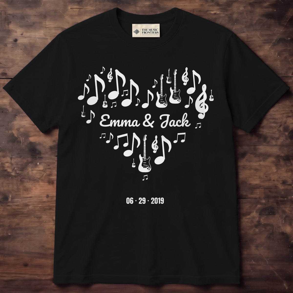 White tee with music notes and two guitars forming a heart around EMMA & JACK and a date