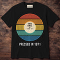 Black shirt with a vinyl record in sunset stripes and a label reading Tom's Vinyl, 33 RPM 1971, Pressed in 1971
