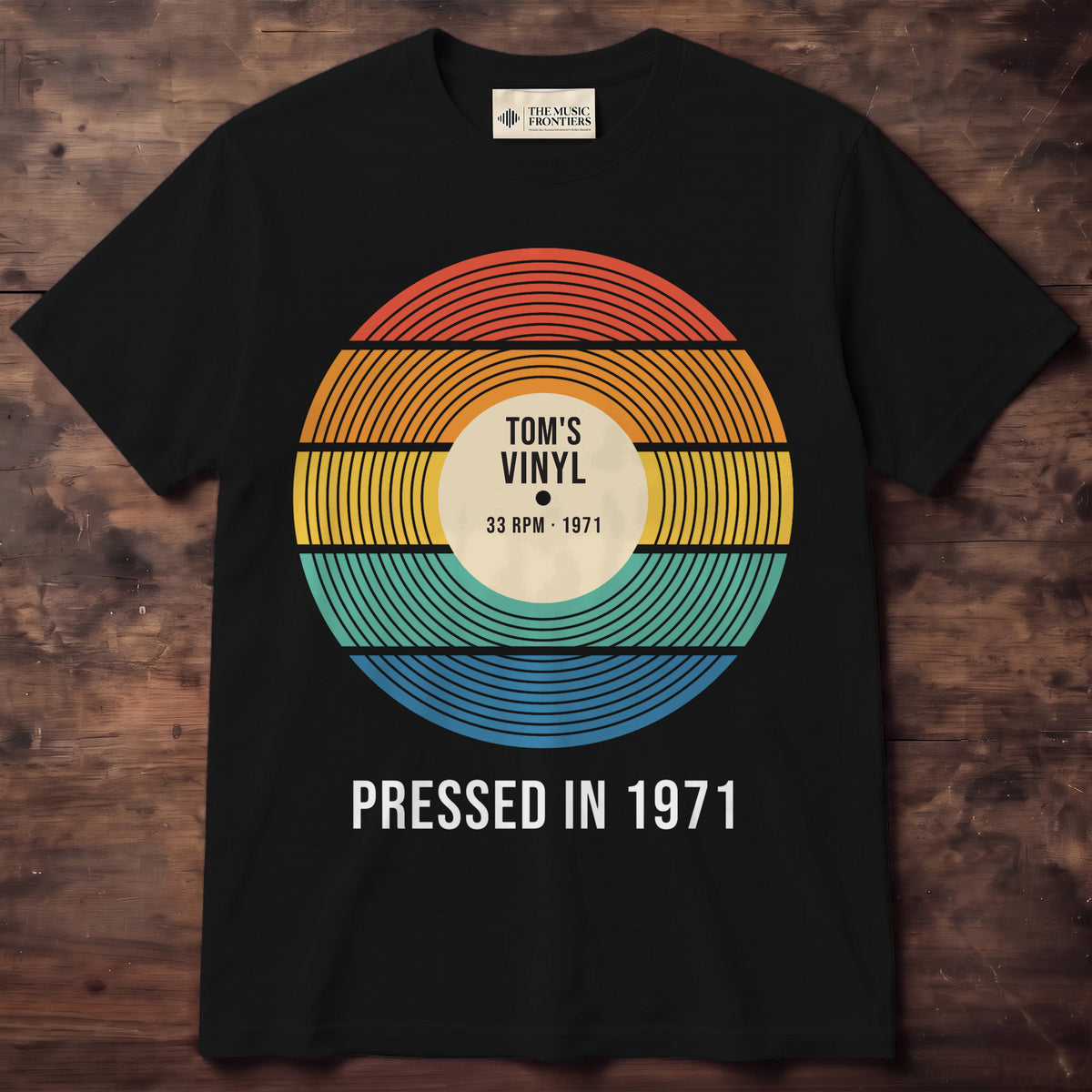Black shirt with a vinyl record in sunset stripes and a label reading Tom's Vinyl, 33 RPM 1971, Pressed in 1971
